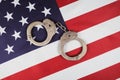 police handcuffs on the usa flag  close-up Royalty Free Stock Photo