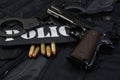 Police handgun with handcuffs on black uniform Royalty Free Stock Photo
