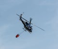 Police helicopter carrying water bucket Royalty Free Stock Photo