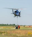 Police helicopter and firefighters filling water bucket