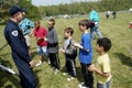 Police helicopter pilot talks to several children and explains how a helicopter works