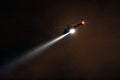Police Helicopter with searchlight at night Royalty Free Stock Photo