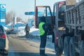 The police inspector of the road service checks the documents of the truck driver