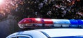 Police lights on car during traffic surveillance on the city road. Flash light on the vehicle of the Emergency Services. Red and Royalty Free Stock Photo