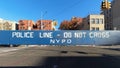 Police line, do not cross, NYPD blue wooden barricade on closed street in the Bronx, New York City