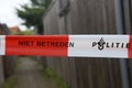 Police lint to block crime scene in Rotterdam with dutch text Politie Niet Betreden no access