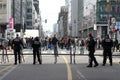 Police look on from behind a barrier at a protest by undocumented migrants, which blocks the Arts-Loi junction in central Brussels Royalty Free Stock Photo