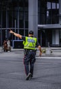 Police man is directing traffic during the rush hour in down town Toronto. Police man regulating traffic on city street Royalty Free Stock Photo