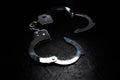 Police metal real handcuffs on the black background. Crime and robbery, prison concept