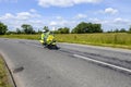 Police motorcycle outrider riding at speed through British countryside Royalty Free Stock Photo