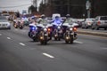 Police motorcycles escort a hearse