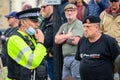 A Police Officer adjusts his PPE face mask and confronts British Anti BLM counter protesters at a Black Lives Matter protest