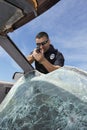 Police Officer Aiming Gun Through Broken Windshield Royalty Free Stock Photo