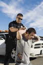 Police Officer Arresting Young Man Royalty Free Stock Photo