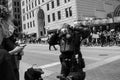 Police officer in body armor stands in front of protestors and puts on a respirator