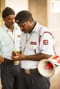 Police officer checking people entrance at hopsital in India