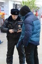 A police officer checks the national database informacionnoi at the entrance to Paveletskaya station.