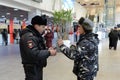 A police officer checks the national database informacionnoi at the entrance to Paveletskaya station.