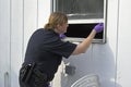 Police officer dusting prints