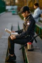 Police officer eating donut in park closeup Royalty Free Stock Photo