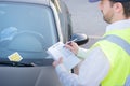 Police officer giving a fine for parking violation Royalty Free Stock Photo