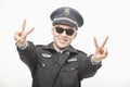 Police Officer Giving Peace Sign, Studio Shot Royalty Free Stock Photo