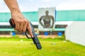 Police officer holding a law enforcement pistol in academy shoot