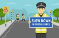 Police officer holding warning poster or sign with slow down in school zones text. School children crossing road on crosswalk.