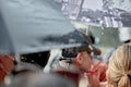 A police officer holds a webcam covered in raindrops