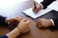 Police officer interrogating  in handcuffs at desk indoors Royalty Free Stock Photo