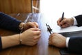 Police officer interrogating criminal in handcuffs at desk Royalty Free Stock Photo