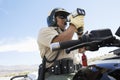 Police Officer Looking Through Radar Gun Royalty Free Stock Photo