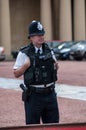 A police officer patrols in front of Buckingham Palace in London during a changing of the guard