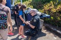 Police officer putting Kevlar vest on a child
