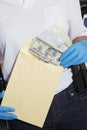 Police Officer Putting Money In Evidence Envelope Royalty Free Stock Photo