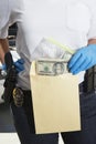 Police Officer Putting Money In Evidence Envelope Royalty Free Stock Photo