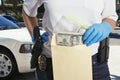 Police Officer Putting Money in Evidence Envelope Royalty Free Stock Photo