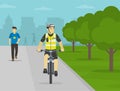 Police officer riding bike on sidewalk at city park. Front view. Royalty Free Stock Photo