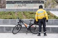 Police Officer Stands In Front of Anti-Police Graffiti