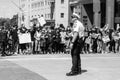 A police officer stands in front of a line of protestors who have linked arms in downtown Columbus Ohio
