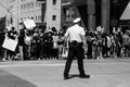 A police officer stands in front of a line of protestors who have linked arms in downtown Columbus Ohio