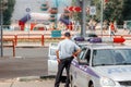 A police officer stands near the vehicle of the traffic police and watches the pedestrian zones