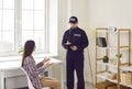 Police officer taking notes on clipboard while interviewing victim of house burglary Royalty Free Stock Photo