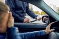 Police officer writes out a protocol to driver