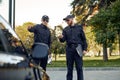 Police officers checking vehicle on car parking Royalty Free Stock Photo
