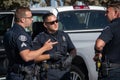 Police Officers from the City of Ventura Police Department have a discussion during a search of a suspect's vehicle.