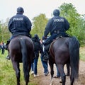 Police officers on horseback riding at the end of a demonstration march