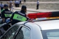 Police officers near the patrol car on a busy city street. The inscription on the back: traffic police