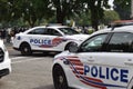 Police officers, police cars and DC municipal trucks serve as a barrier on Third Street next to the Justice of J6 Protest