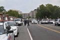 Police officers, police cars and DC municipal trucks serve as a barrier on Third Street next to the Justice of J6 Protest